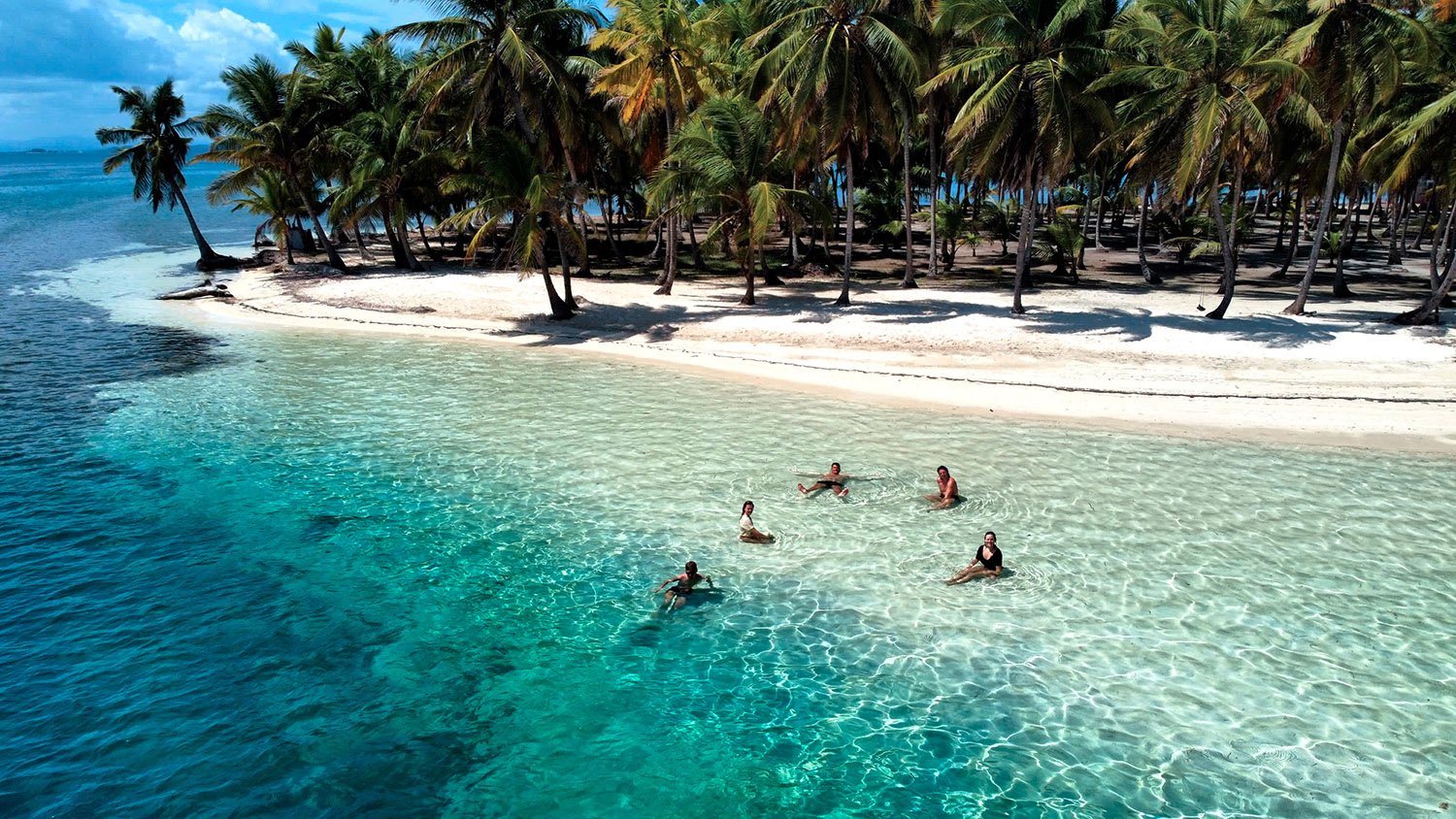 People swimming in clear turquoise water